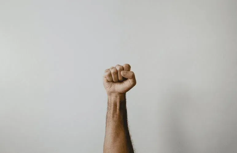 A product manager lifting their fist in the air.