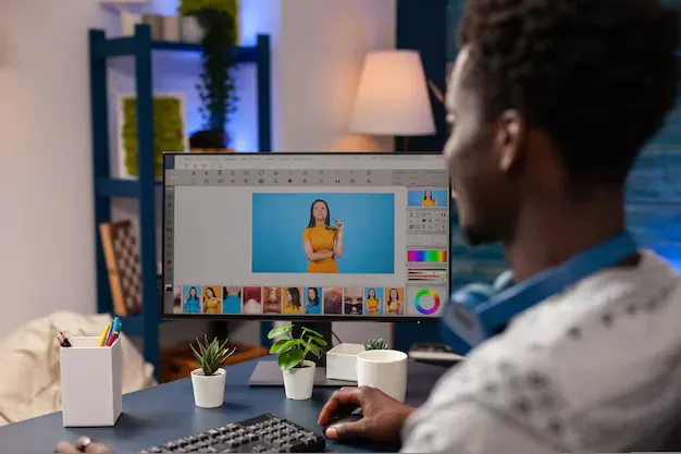 A person edits the framing of a video on a desktop computer