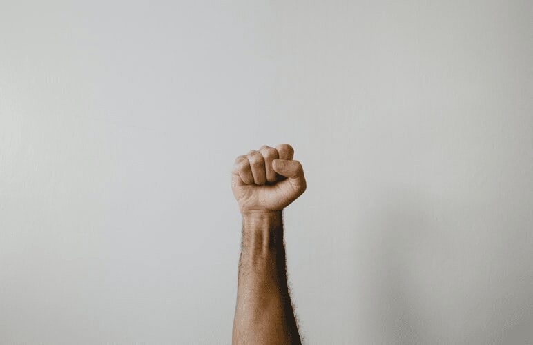 A product manager lifting their fist in the air.
